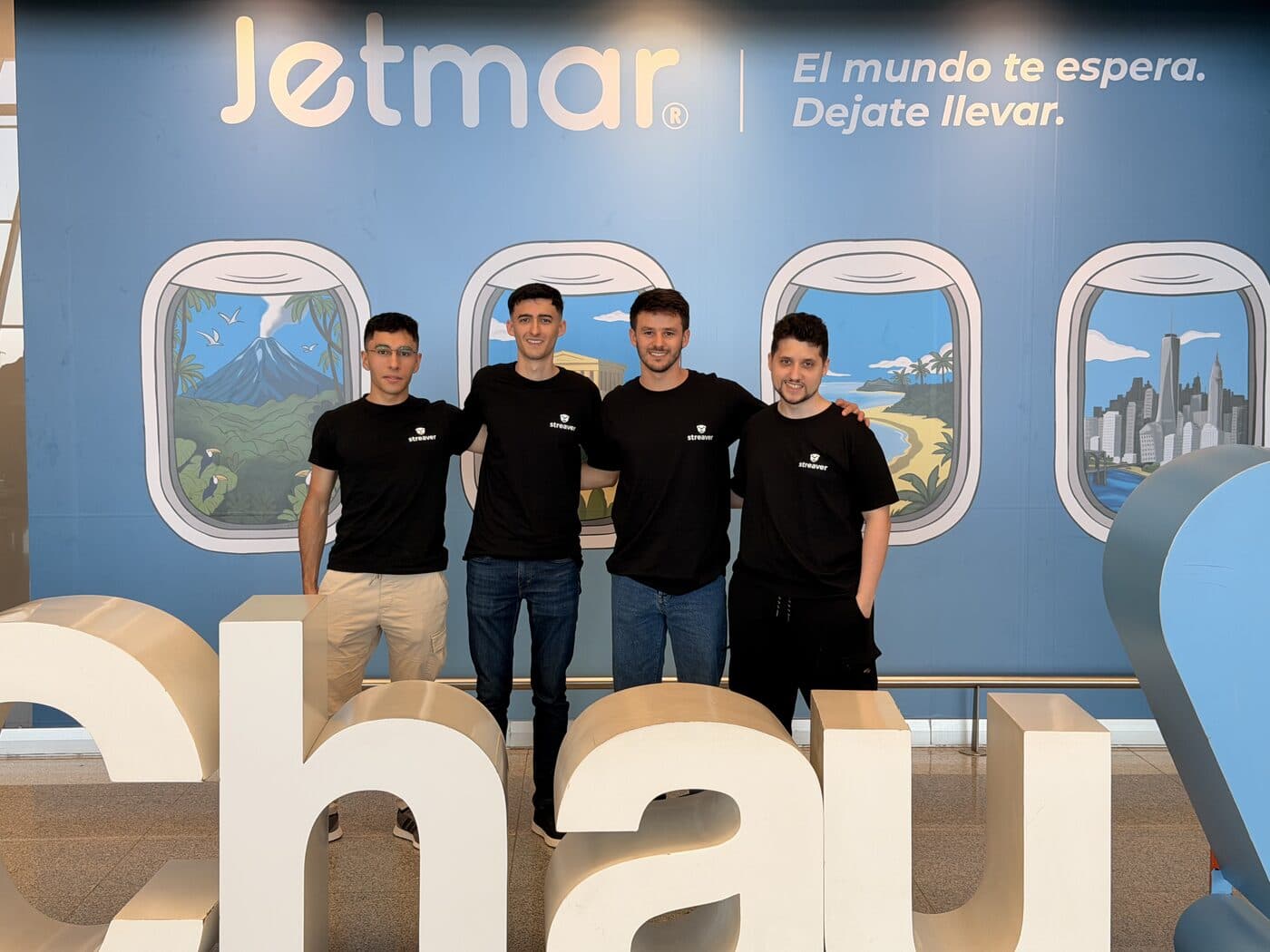 Four Streaver engineers in branded black t-shirts at the airport, heading out for the second trip.