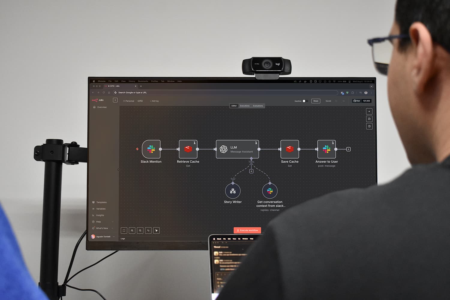 Engineer reviewing an n8n agentic workflow on a monitor