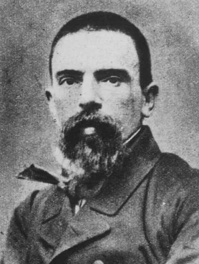 Photographic portrait of Juan Manuel Blanes, about 1872: a bearded man in a dark buttoned coat.